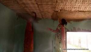 Local women plastering the false roof with clay and cow dung.