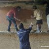 Participants and local mason learning lime plaster application