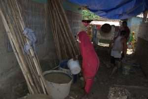 Preparing clay for the hempcrete mix.